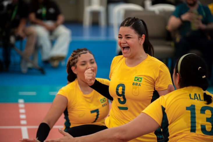 The photo has the womens brazilian tem celebrating at the court.